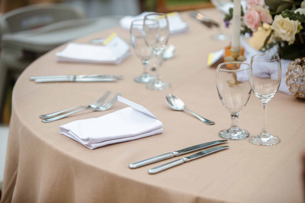 Close up of a table setting with cutlery and glasses