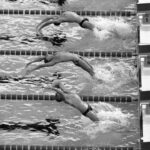 Five swimmers dive into a pool in synchronized motion during a Type II competition, creating splashes as they enter the water.