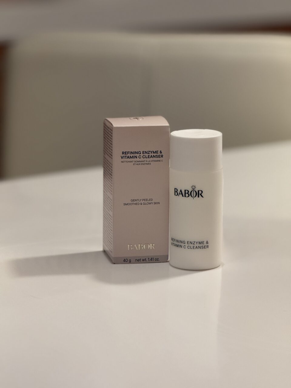 A box and bottle of BABOR Refining Enzyme & Vitamin C Cleanser are displayed on a light-colored surface with a blurred background.